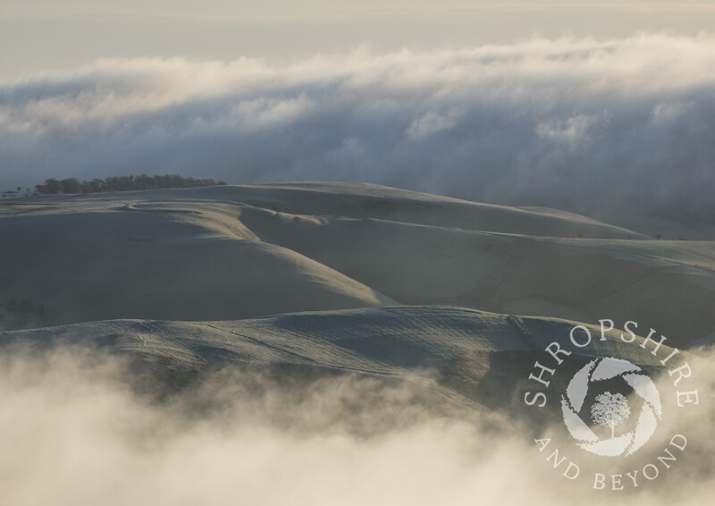 Mist swirls around Ratlinghope Hill, seen from the Stiperstones, Shropshire.