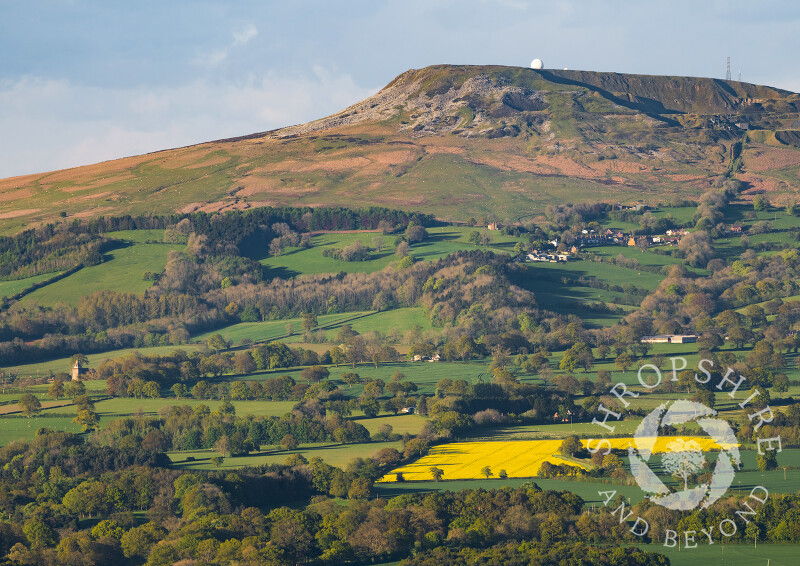 Evening sunlight on Titterstone Clee Hill and the village of Bedlam, Shropshire.
