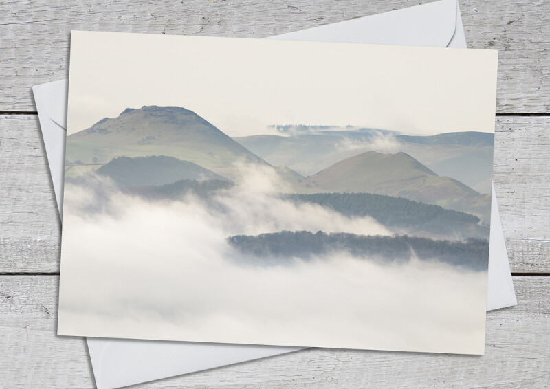Mist surrounds the Stretton Hills, seen from the Wrekin, Shropshire.