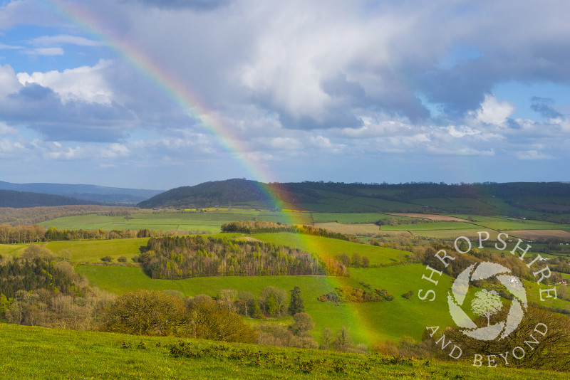 A rainbow over the south Shropshire countryside seen from Burrow Hill, near Craven Arms, Shropshire, England.