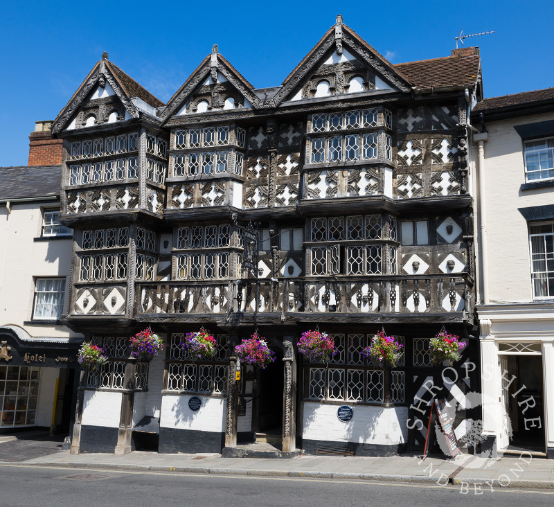 Hanging baskets outside the Feathers Hotel in Ludlow, Shropshire, England.