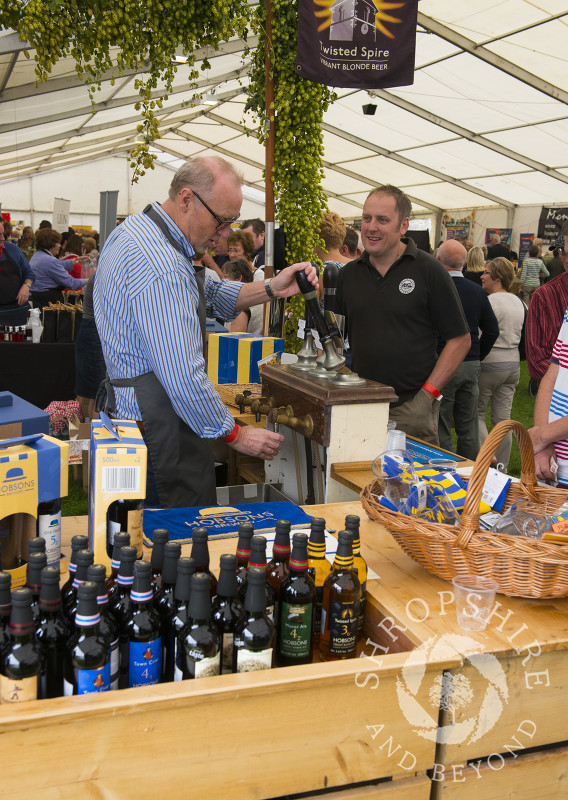 Pulling pints at the Hobsons Brewery stall at Ludlow Food Festival, Shropshire.