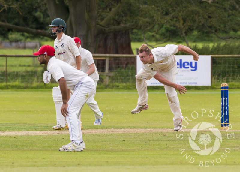 A cricket match in progress at Davenport Park, Worfield, Shropshire. Members of Streetly Cricket Club are seen bowling against Worfield.