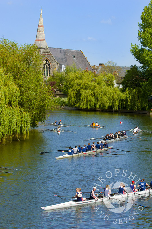 Shrewsbury United Reformed Church overlooks rowing boats on the River Severn during Shrewsbury Regatta, Shropshire, England.