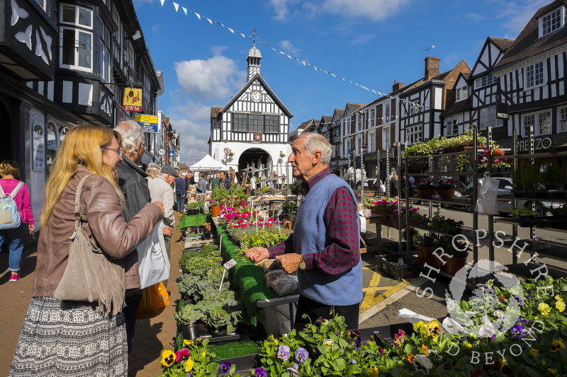 A market trader serves a customer in High Street, Bridgnorth, Shropshire.