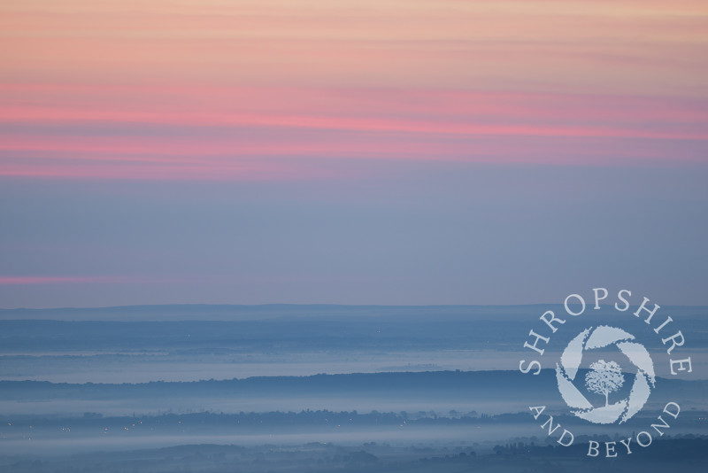 The view towards Shrewsbury and Haughmond Hill at dawn, seen from Habberley Rocks on the Stiperstones, Shropshire.