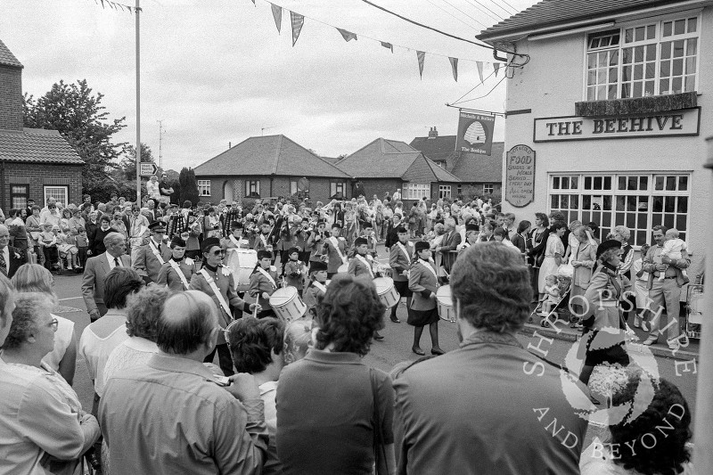 The parade passes the Beehive public house and heads into Curriers Lane during the annual carnival in Shifnal, Shropshire, in June 1987.