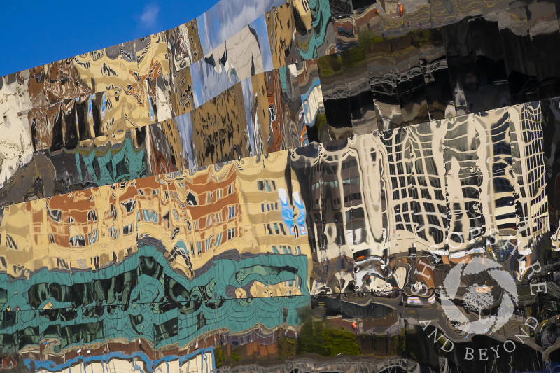 City centre buildings reflected in the outer wall of the new Grand Central shopping centre, Birmingham, West Midlands.