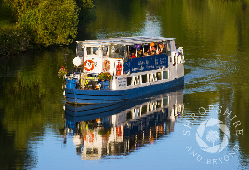 Sabrina pleasure boat reflected in the water of the River Severn in Shrewsbury, Shropshire.