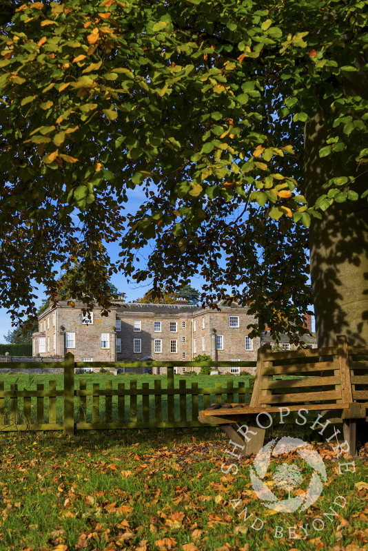 Autumn sunshine on bench in front of 16th century Morville Hall, near Bridgnorth, Shropshire.