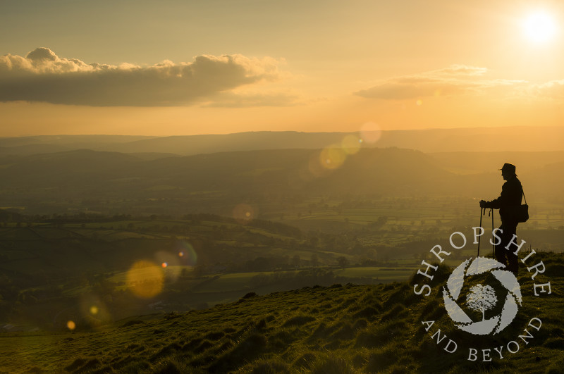 A walker pauses on the Shropshire Way footpath on top of Brown Clee Hill in Shropshire.