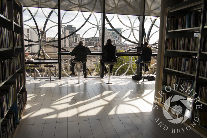 People studying inside the Library of Birmingham, England, UK.