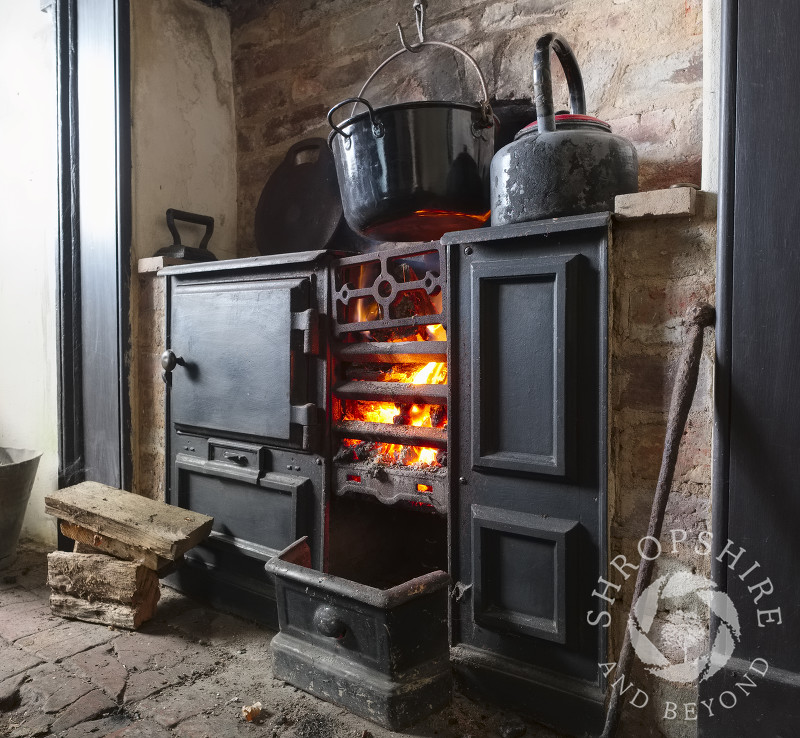 A roaring fire in a cast iron range at one of the miners' cottages on the Stiperstones National Nature Reserve at Blakemoorgate, near Snailbeach, Shropshire.