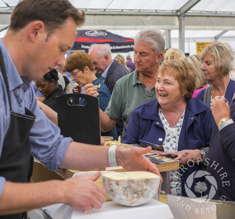 Visitors queue up for cheese at Ludlow Food Festival, Shropshire.