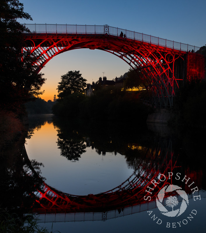 The Iron Bridge reflected in the River Severn at Ironbridge, Shropshire, England.