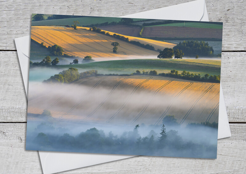 Misty sunrise over fields near Clun, Shropshire.