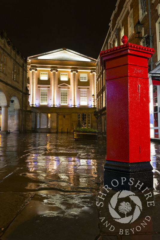 Vintage pillar box and Shrewsbury Museum and Art Gallery seen on a rainy night, The Square, Shrewsbury, Shropshire.