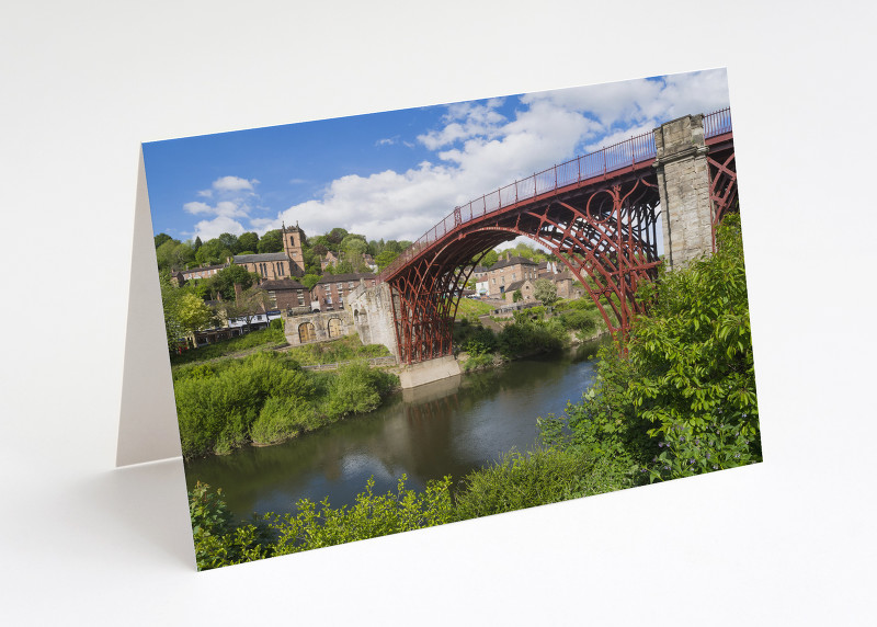 The Iron Bridge reflected in the River Severn at Ironbridge, Shropshire.