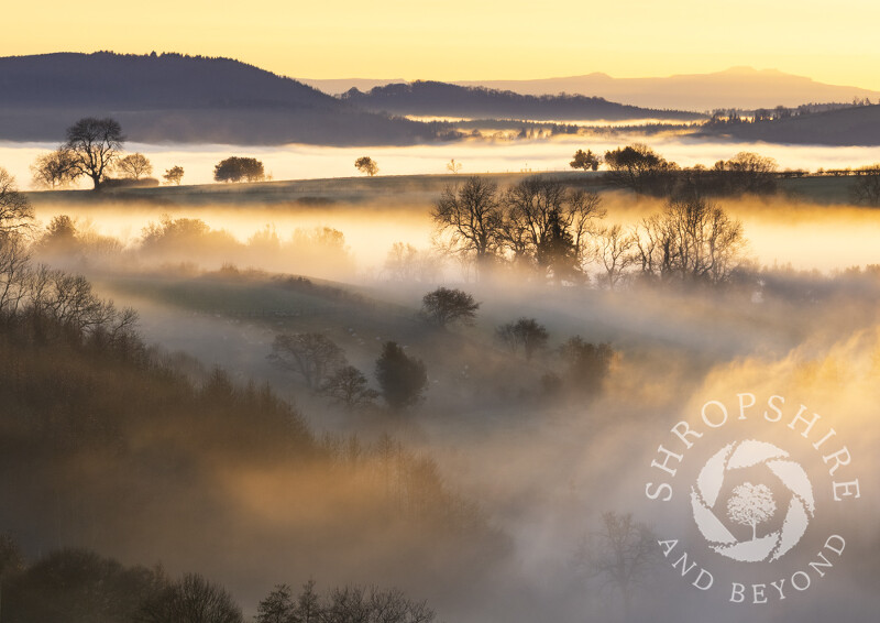 Misty sunset in the Corvedale, Shropshire, with the Brecon Beacons on the horizon.