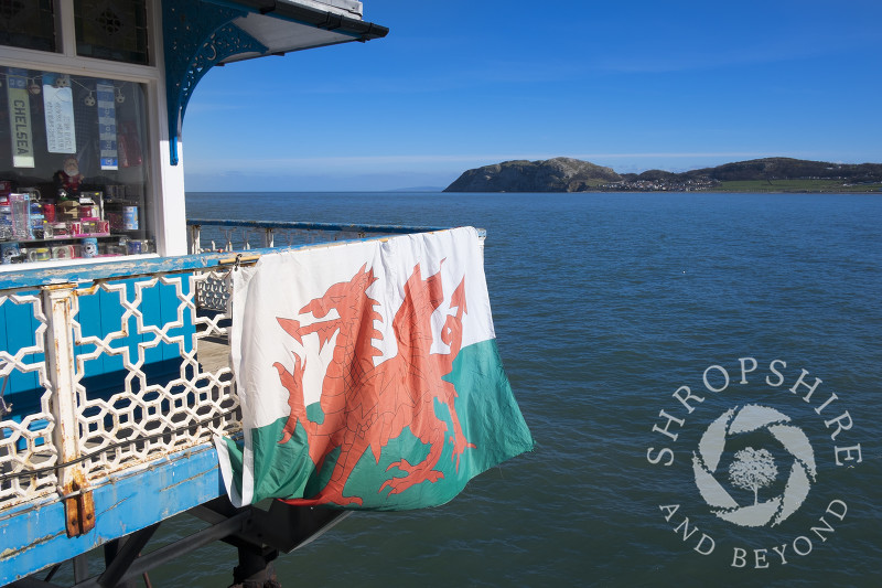 A Welsh flag displayed outside a kiosk on Llandudno Pier, North Wales.