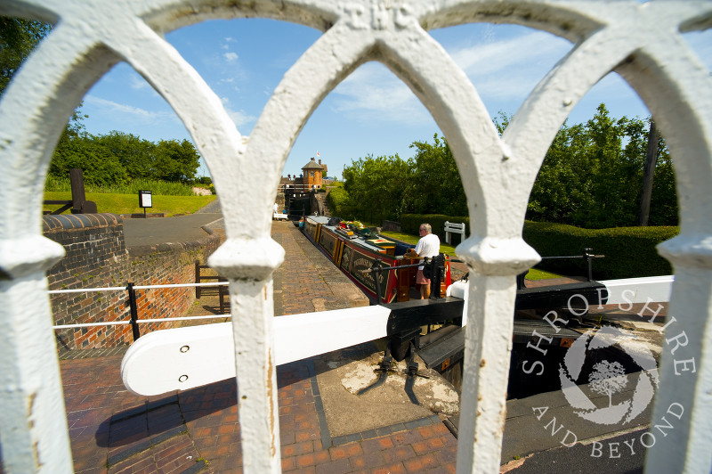 A canal boat passing through Bratch Locks at Wombourne, Staffordshire, England.