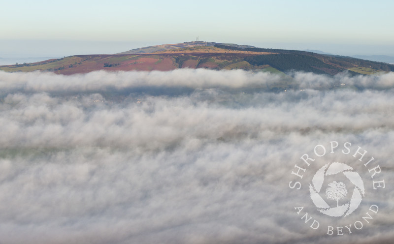 Mist swirls around Brown Clee Hill in Shropshire.