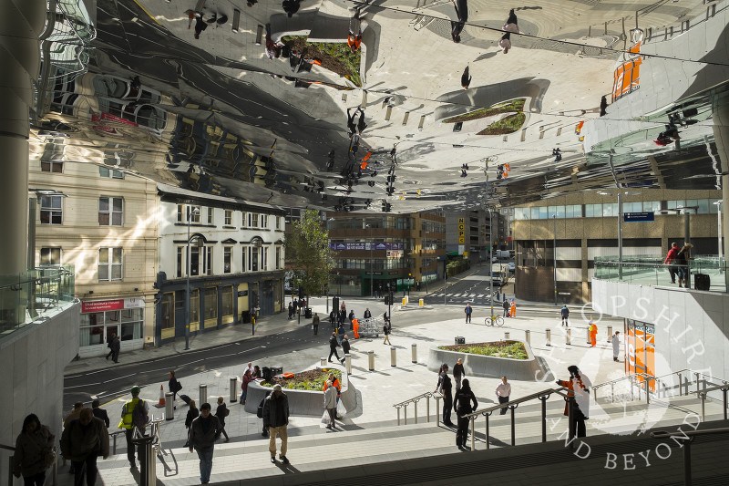 Pedestrians reflected in the ceiling at the entrance to the Grand Central shopping centre, above the newly renovated New Street railway station, Birmingham, West Midlands.