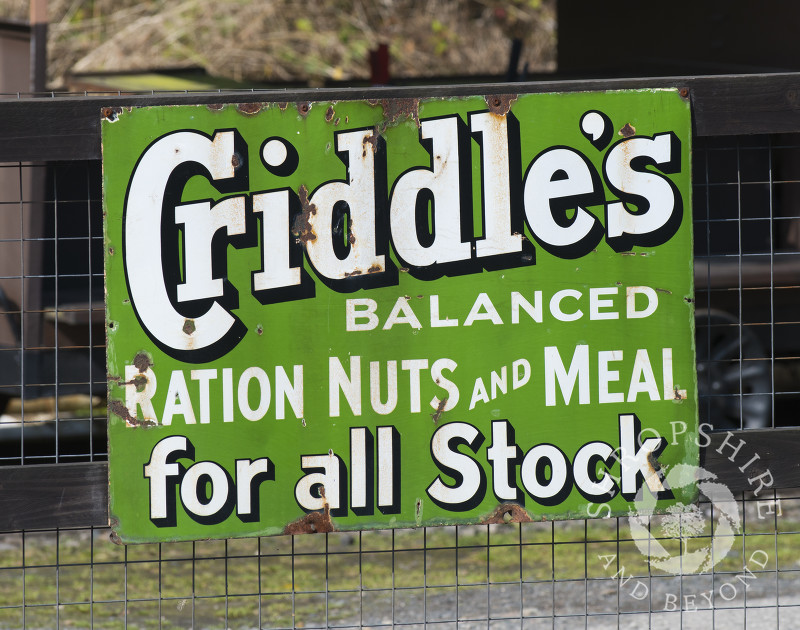 Vintage enamel sign advertising Criddle's ration nuts and meal for stock at Highley Station, Shropshire, on the Severn Valley Railway heritage line.