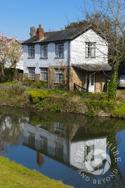 A house reflected in the waters of the River Arrow at Eardisland, Herefordshire, England.