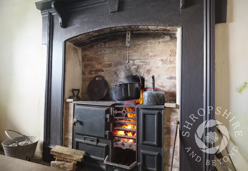 A roaring fire in a cast iron range at one of the miners' cottages on the Stiperstones National Nature Reserve at Blakemoorgate, near Snailbeach, Shropshire.