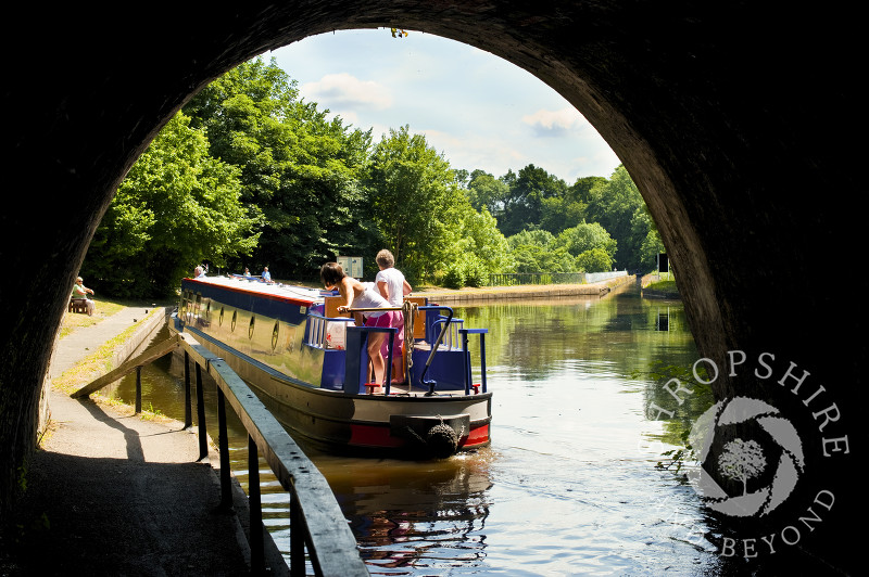 A canal boat leaving Darkie Tunnel at Chirk, Wrexham, Wales.