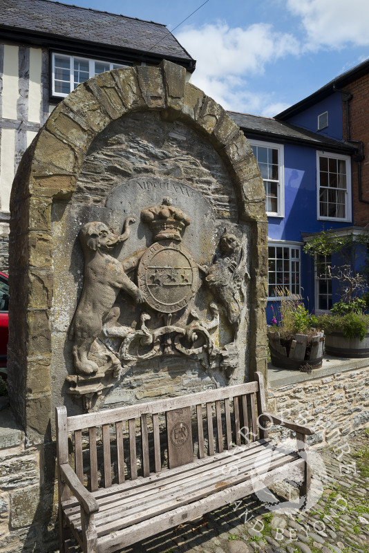 The coat of arms of the Earls of Powis in the Old Market Place, Bishop's Castle, Shropshire, England. The stone is a relic of the old market hall.