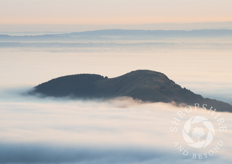 Earl's Hill and Pontesford Hill rise above the mist, Shropshire.