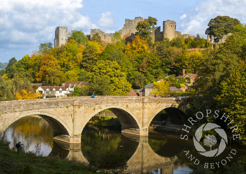 Autumn sunshine highlights Dinham Bridge, the River Teme and Ludlow Castle, Shropshire.